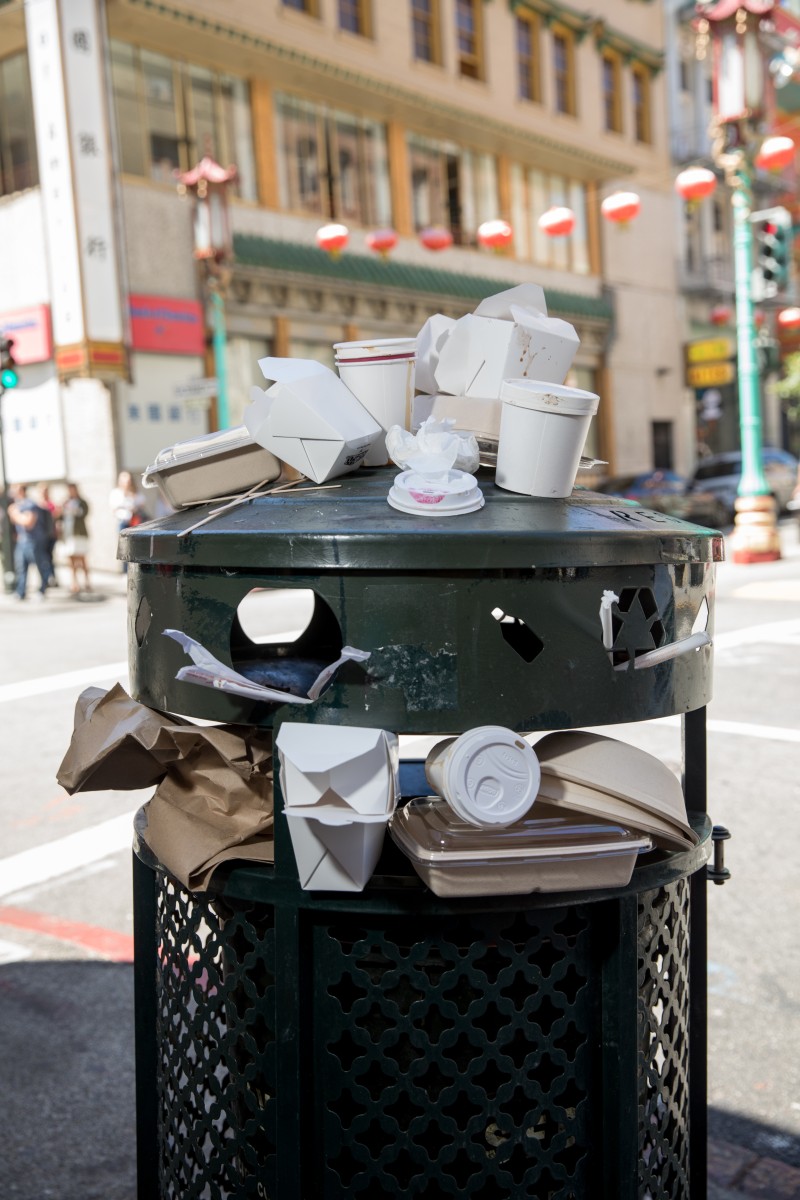 Disposable cups and litter on top of a trash can in San Francisco's Chinatown neighborhood